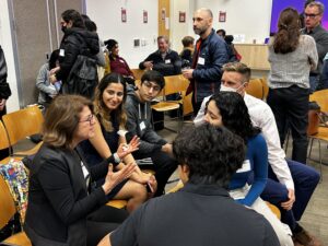 Students talk during a break at the C&C Forum.