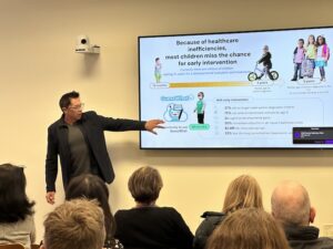 Dennis Wall explains his newest research project to an audience at the Collaboration and Careers Forum