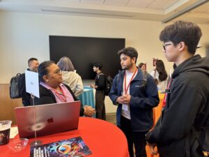 Tanveer Syeda-Mahmood and students talking to each other during the networking session.
